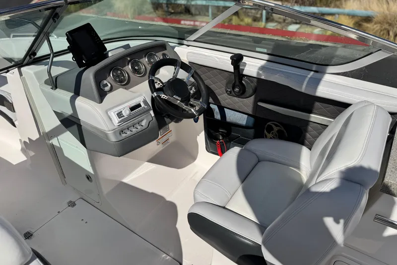 Slide: The Image of 2014 Regal 27 FasDeck boat interior with steering wheel and dashboard controls. - 29