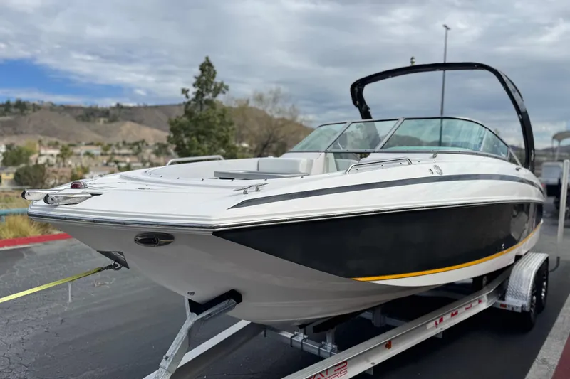 Slide: The Image of 2014 Regal 27 FasDeck boat on trailer with scenic mountain backdrop. - 3