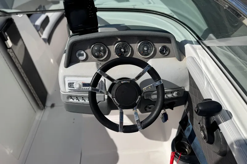 Slide: The Image of 2014 Regal 27 FasDeck boat dashboard with steering wheel and instrument panel. - 30