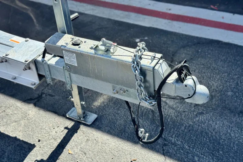 Slide: The Image of Trailer hitch with chains and lock for 2014 Regal 27 FasDeck boat. - 33