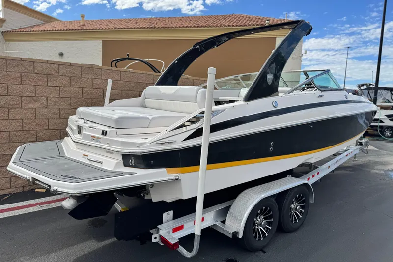 Slide: The Image of 2014 Regal 27 FasDeck boat on trailer, featuring sleek design and spacious seating. - 5