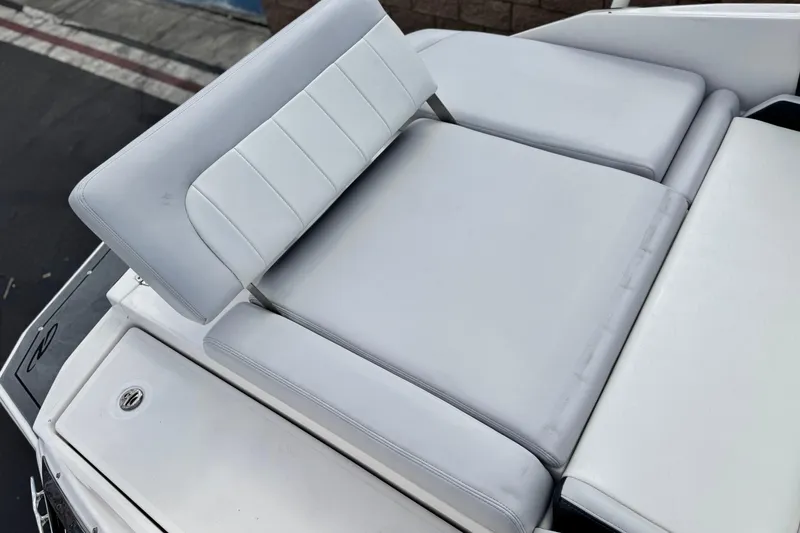 Slide: The Image of 2014 Regal 27 FasDeck boat with white cushioned seating area. - 9