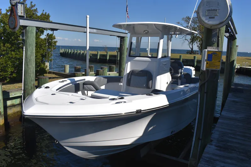 Slide: The Image of 2025 NauticStar 242L Offshore boat docked by the water. - 13