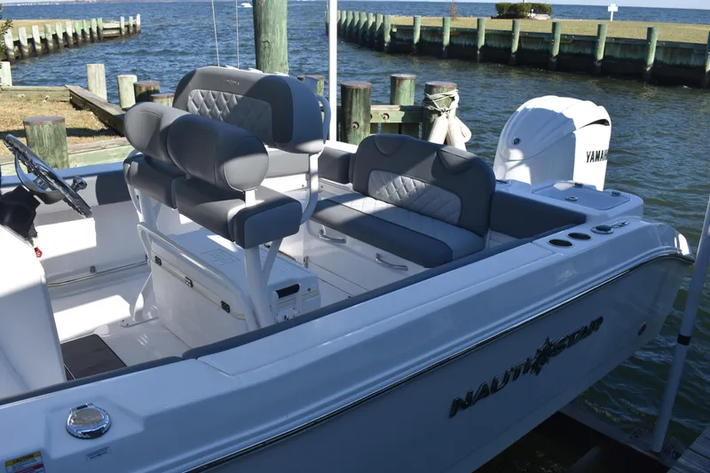 Slide: The Image of 2025 NauticStar 242L Offshore boat with Yamaha engine, docked by the water. - 15