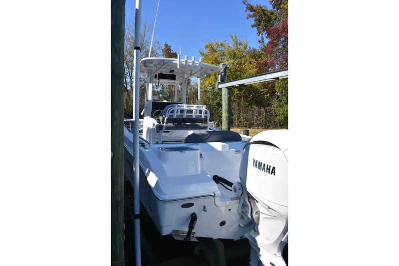 Slide: The Image of 2025 NauticStar 242L Offshore boat with Yamaha engine, docked outdoors. - 17
