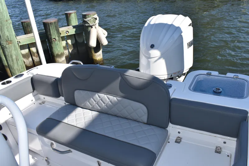 Slide: The Image of 2025 NauticStar 242L Offshore boat with Yamaha engine, featuring cushioned seating and water backdrop. - 19