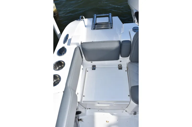 Slide: The Image of 2025 NauticStar 242L Offshore boat interior with seating and cup holders. - 21