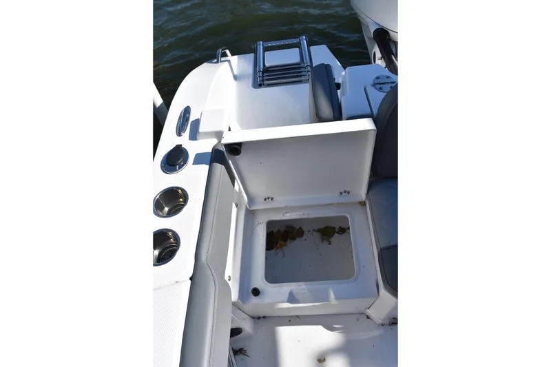 Slide: The Image of 2025 NauticStar 242L Offshore boat interior with storage compartment and seating. - 22