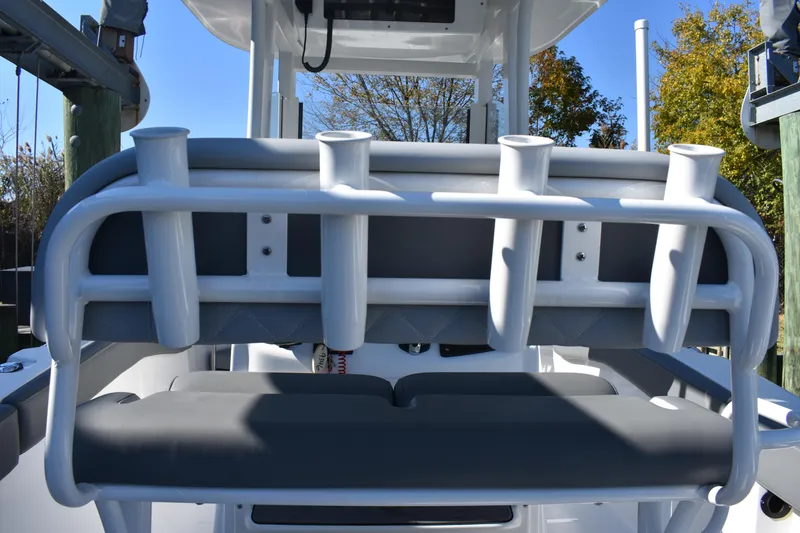 Slide: The Image of 2025 NauticStar 242L Offshore boat with rod holders and cushioned seating. - 32