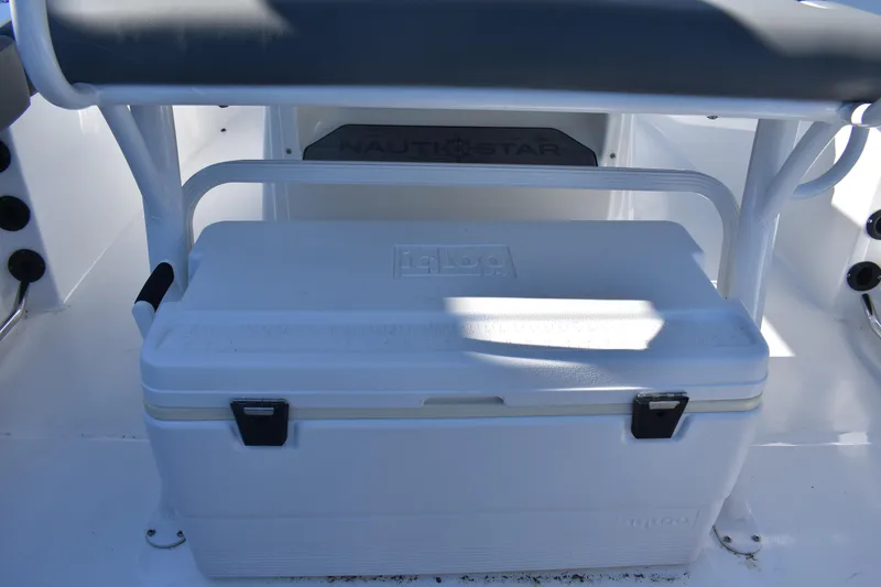 Slide: The Image of 2025 NauticStar 242L Offshore boat interior with Igloo cooler storage. - 33