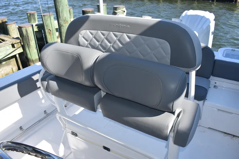 Slide: The Image of 2025 NauticStar 242L Offshore boat seating with gray upholstery and diamond stitching. - 36