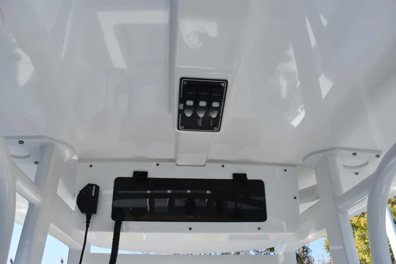 Slide: The Image of 2025 NauticStar 242L Offshore boat console with control panel and radio equipment. - 37