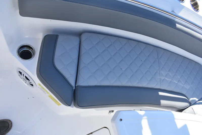 Slide: The Image of 2025 NauticStar 242L Offshore boat seat with quilted gray upholstery. - 44