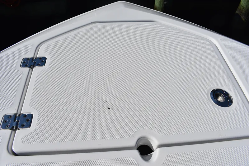 Slide: The Image of 2025 NauticStar 242L Offshore boat deck with textured surface and metal fittings. - 46