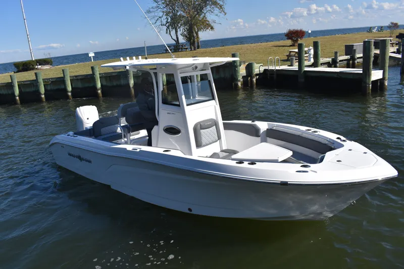 Slide: The Image of 2025 NauticStar 242L Offshore boat docked on calm water, clear sky background. - 55