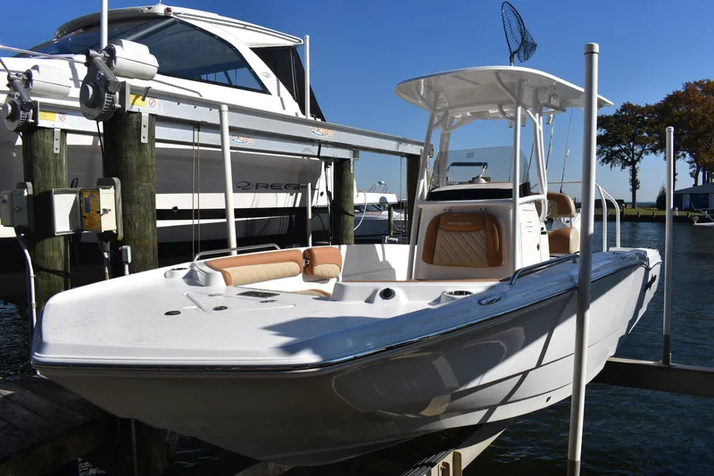 Slide: The Image of 2025 NauticStar 231 Hybrid boat docked, featuring sleek design and modern amenities. - 13