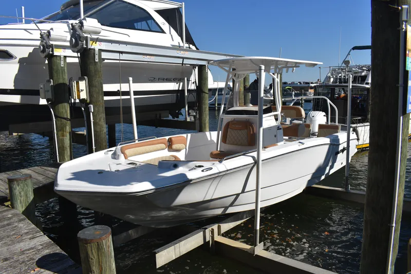 Slide: The Image of 2025 NauticStar 231 Hybrid boat docked at marina, featuring sleek design and modern amenities. - 16