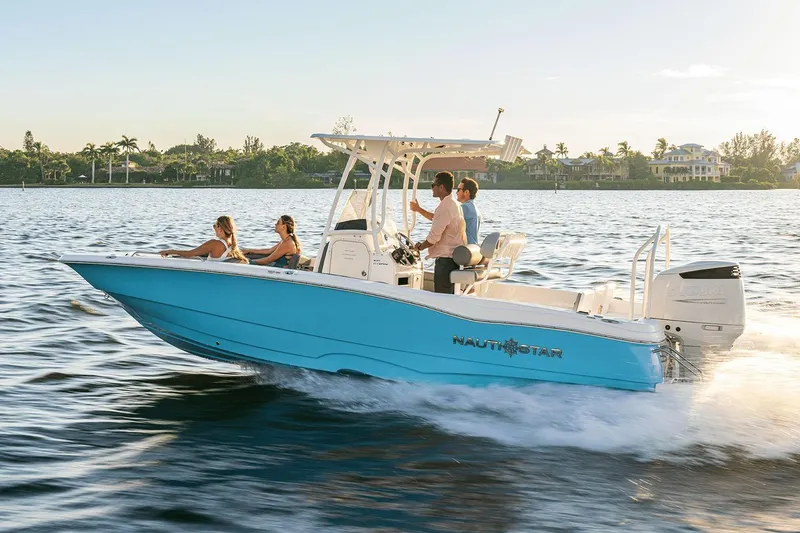 Slide: The Image of 2025 NauticStar 231 Hybrid boat cruising in a marina, featuring sleek design and modern amenities. - 2