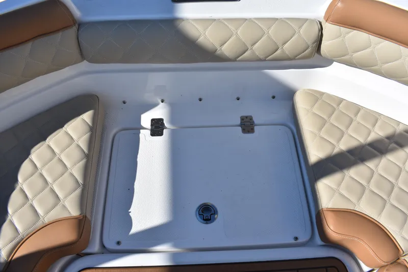 Slide: The Image of 2025 NauticStar 231 Hybrid boat seating with quilted upholstery and storage compartment. - 22