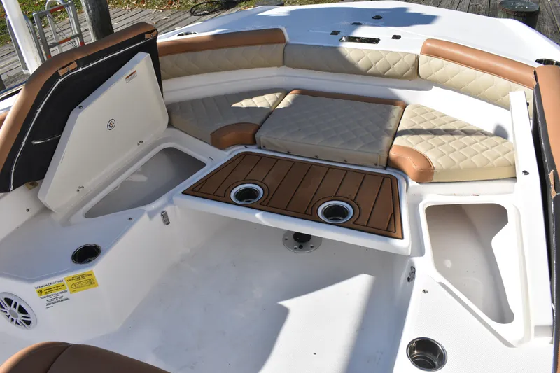 Slide: The Image of 2025 NauticStar 231 Hybrid boat interior with cushioned seating and storage compartments. - 24