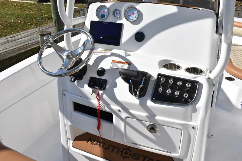 Slide: The Image of 2025 NauticStar 231 Hybrid boat console with steering wheel and control panel. - 35