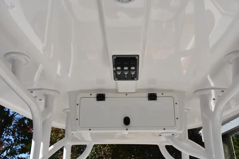 Slide: The Image of 2025 NauticStar 231 Hybrid boat console with switches and storage compartment. - 36