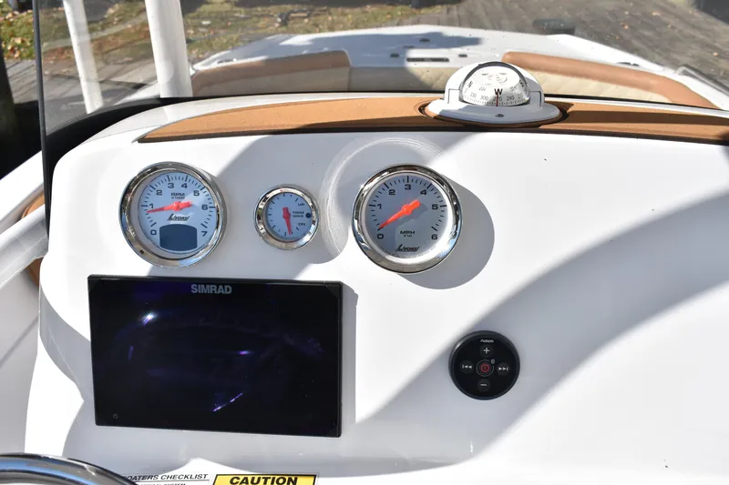 Slide: The Image of Dashboard of 2025 NauticStar 231 Hybrid boat with gauges and navigation equipment. - 38