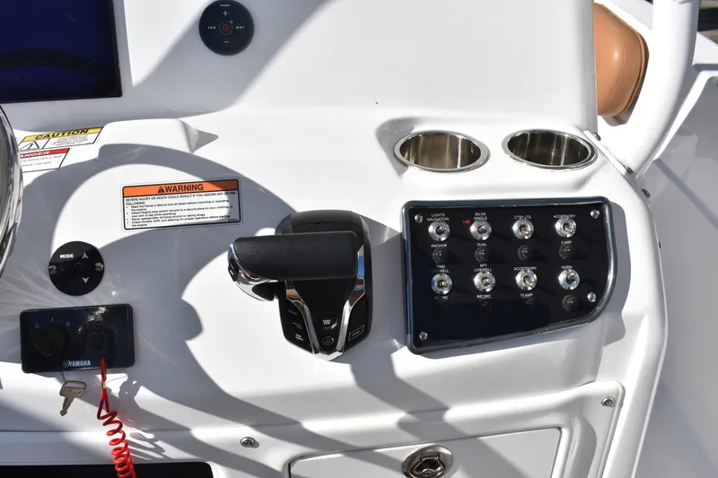 Slide: The Image of Control panel of 2025 NauticStar 231 Hybrid boat with switches and throttle. - 40