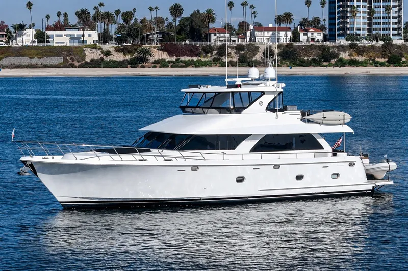 Slide: The Image of 2010 Ocean Alexander Motor Yacht on calm water near a coastal cityscape. - 10