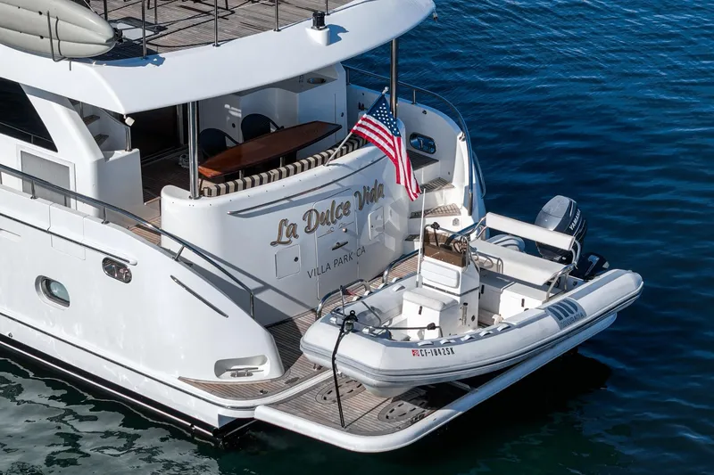 Slide: The Image of Ocean Alexander 2010 motor yacht with tender, American flag, and "La Dolce Vita" name. - 12