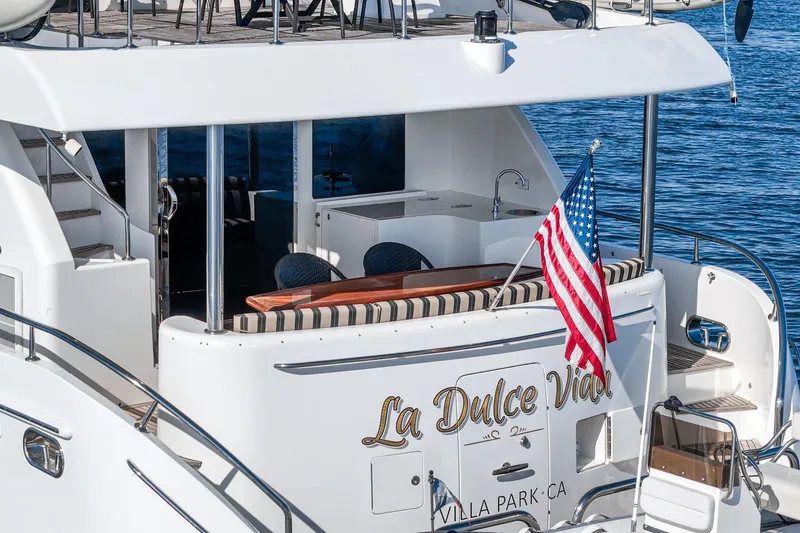 Slide: The Image of Ocean Alexander 2010 motor yacht with American flag, named "La Dulce Vida," docked in calm waters. - 15