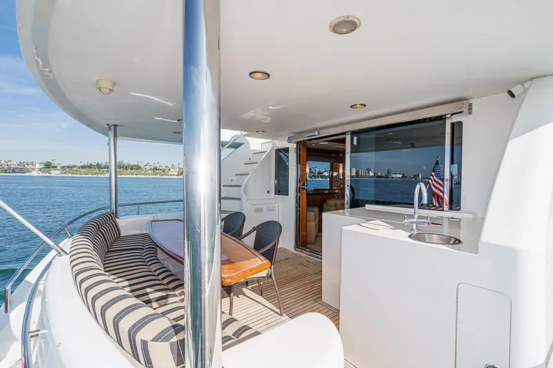 Slide: The Image of Luxurious 2010 Ocean Alexander Motor Yacht deck with seating, table, and ocean view. - 16