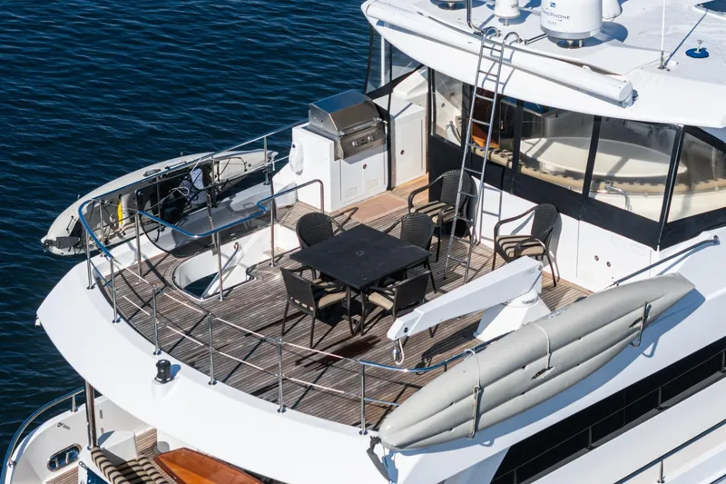 Slide: The Image of 2010 Ocean Alexander Motor Yacht deck with dining area and watercraft. - 31