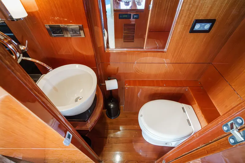 Slide: The Image of Luxurious 2010 Ocean Alexander motor yacht bathroom with wooden finish and modern fixtures. - 37