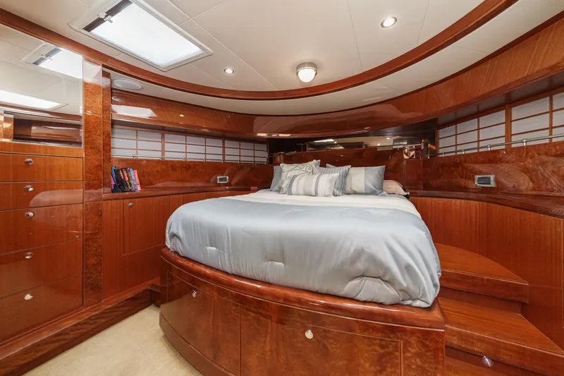 Slide: The Image of Luxurious 2010 Ocean Alexander motor yacht bedroom with elegant wood finish and plush bedding. - 52