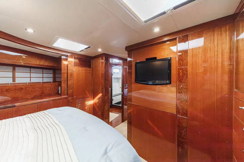 Slide: The Image of Luxurious 2010 Ocean Alexander motor yacht bedroom with wood paneling and TV. - 54