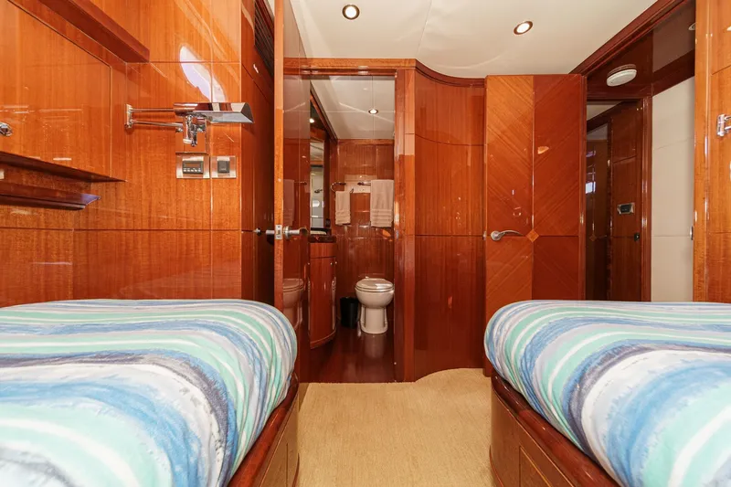 Slide: The Image of Luxurious 2010 Ocean Alexander motor yacht cabin with twin beds and en-suite bathroom. - 57