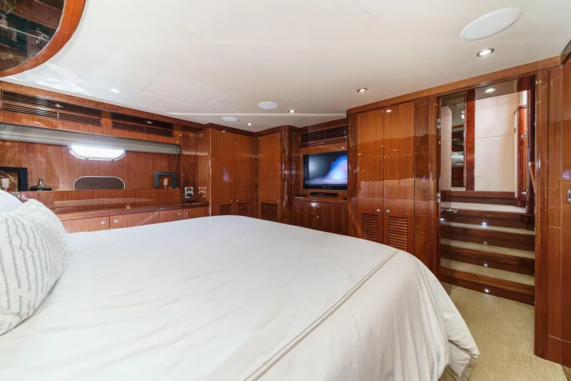 Slide: The Image of Luxurious 2010 Ocean Alexander motor yacht bedroom with wood paneling and modern amenities. - 61