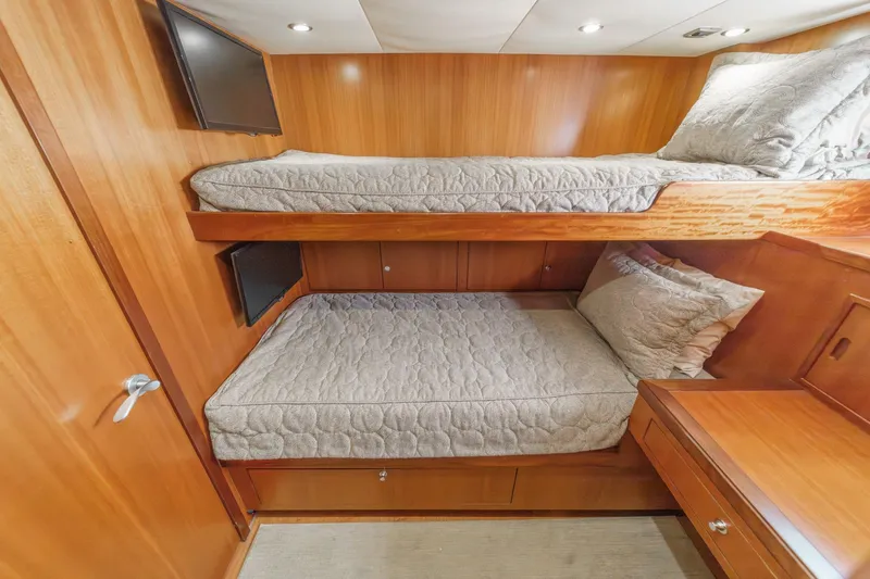 Slide: The Image of Luxurious 2010 Ocean Alexander motor yacht cabin with cozy bunk beds and elegant wood finish. - 65