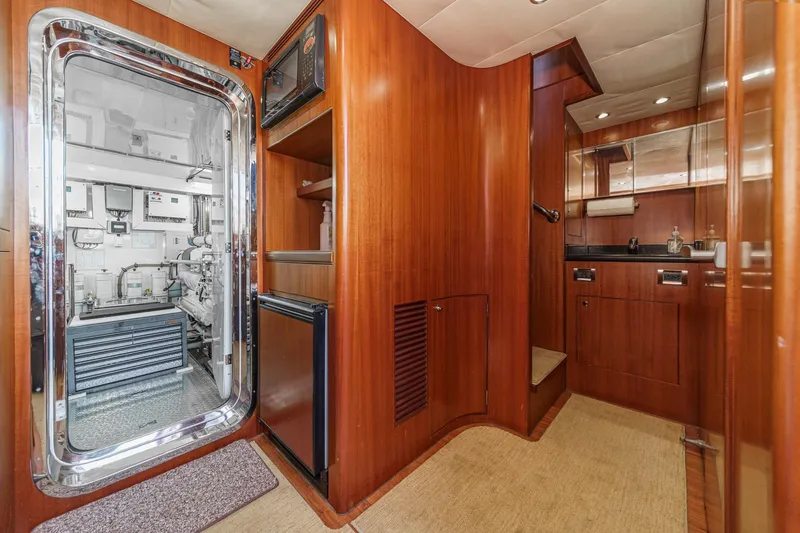 Slide: The Image of Luxurious 2010 Ocean Alexander motor yacht interior with wood paneling and modern amenities. - 67