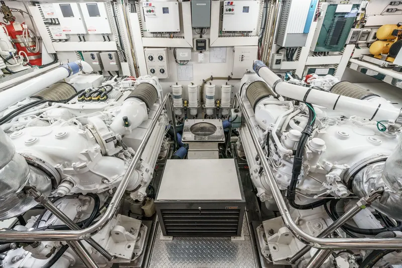 Slide: The Image of Engine room of a 2010 Ocean Alexander Motor Yacht, featuring dual engines and control panels. - 69