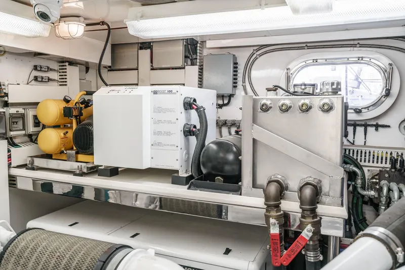 Slide: The Image of Engine room of a 2010 Ocean Alexander Motor Yacht, featuring machinery and equipment. - 82