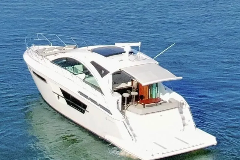 Slide: The Image of 2022 Cruisers Yachts 54 Cantius luxury yacht on open water. - 10