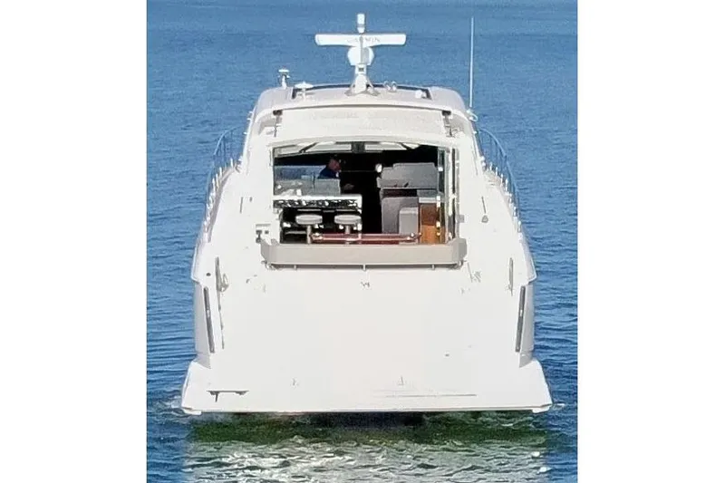 Slide: The Image of 2022 Cruisers Yachts 54 Cantius on calm water, rear view. - 2