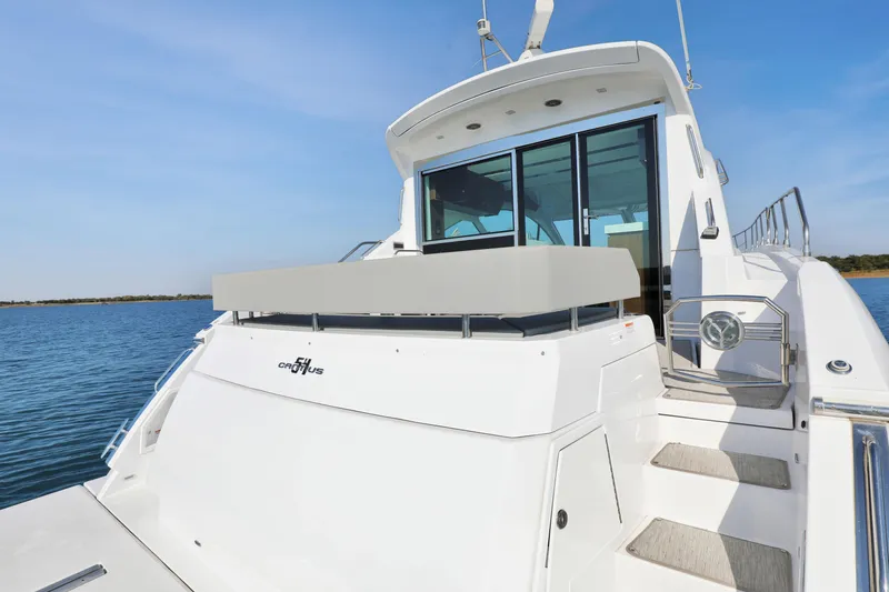 Slide: The Image of 2022 Cruisers Yachts 54 Cantius on water, showcasing sleek design and modern features. - 22