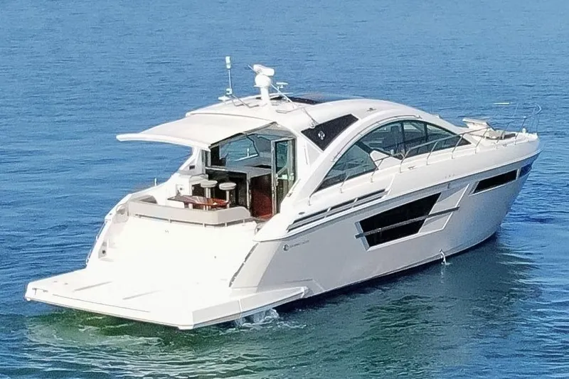 Slide: The Image of 2022 Cruisers Yachts 54 Cantius on calm blue water, showcasing sleek design and luxury features. - 3