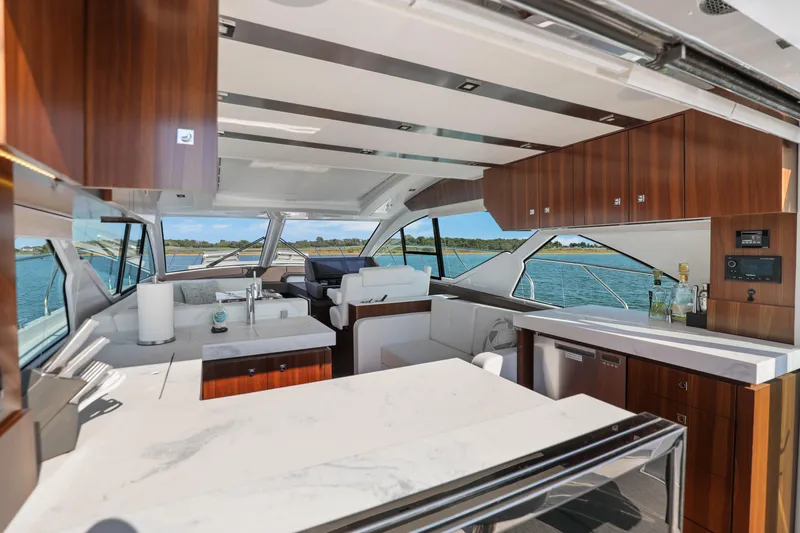 Slide: The Image of Luxurious interior of 2022 Cruisers Yachts 54 Cantius with modern kitchen and scenic views. - 31