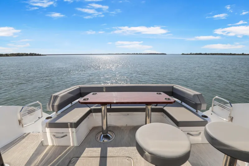 Slide: The Image of 2022 Cruisers Yachts 54 Cantius deck with seating and ocean view. - 32