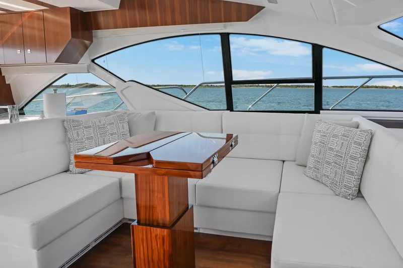 Slide: The Image of Luxurious interior of 2022 Cruisers Yachts 54 Cantius with elegant seating and wooden table. - 36