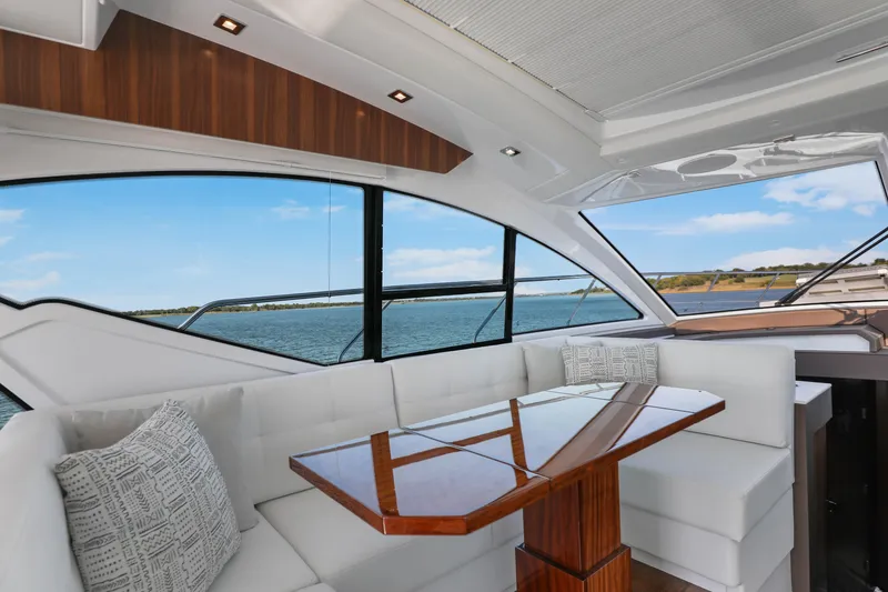 Slide: The Image of Luxurious interior of 2022 Cruisers Yachts 54 Cantius with elegant seating and scenic water view. - 37